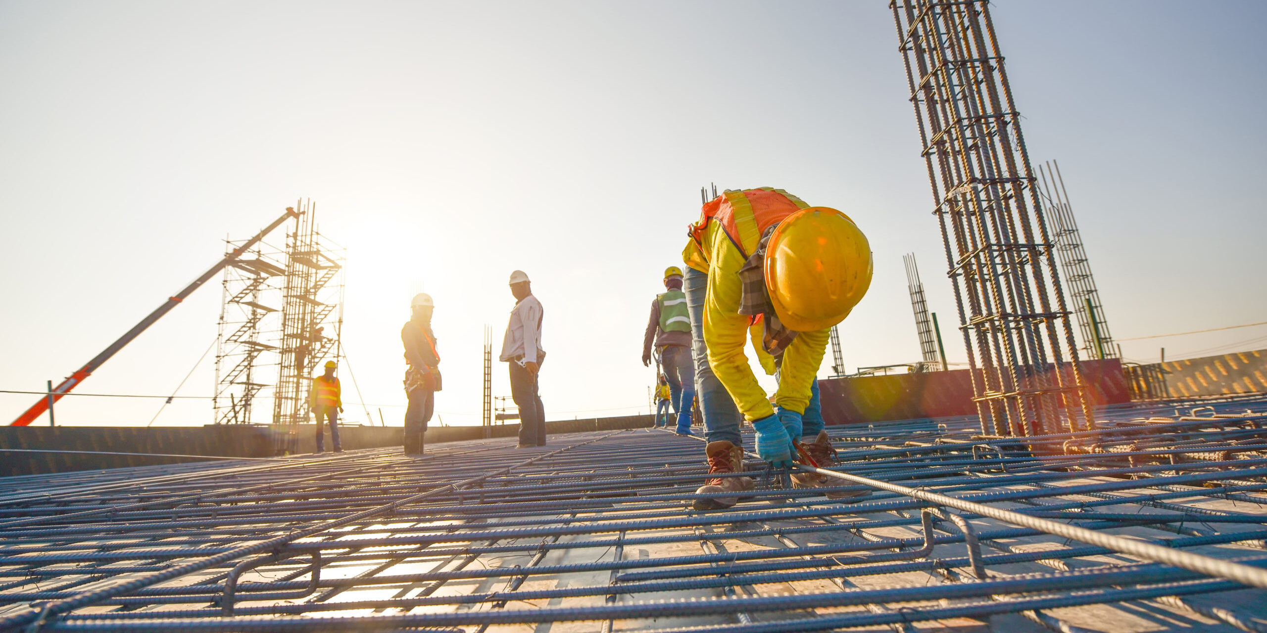 Construction workers fabricating steel reinforcement bar at the